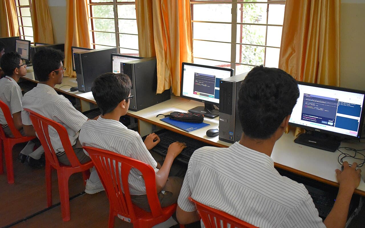Students working at computers in a school computer lab.